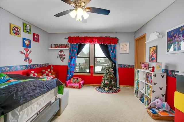 a bedroom with bed and a chandelier