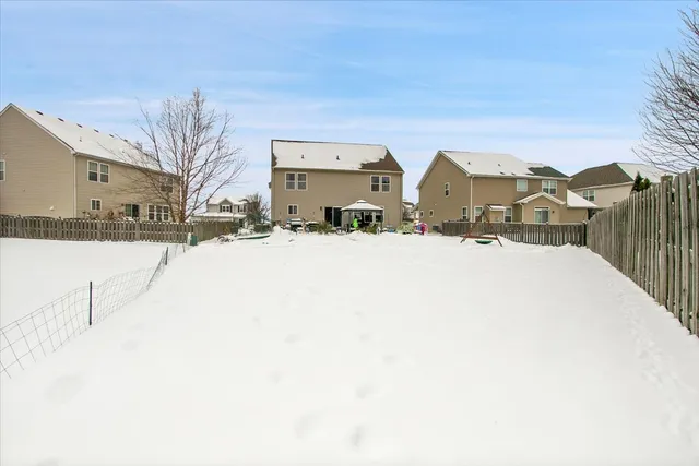 a view of a white house with a snow in front of it