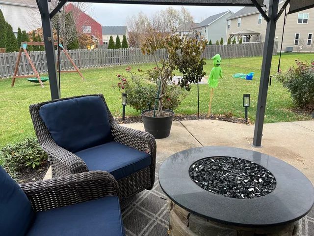 a view of a porch with furniture and a garden