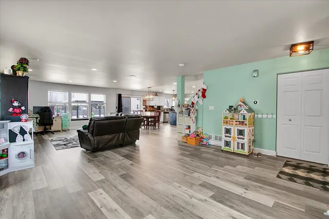 a living room with furniture and a wooden floor