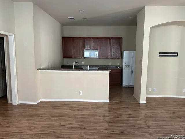 a kitchen with stainless steel appliances granite countertop a sink stove and wooden floor