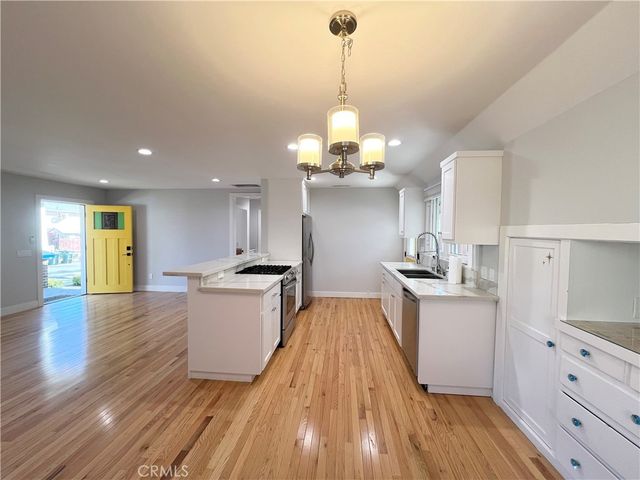 a stove top oven sitting inside of a kitchen