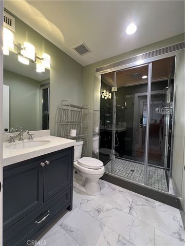 a bathroom with a glass shower door