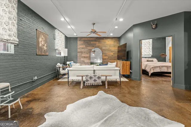 a living room with furniture a rug and a large window