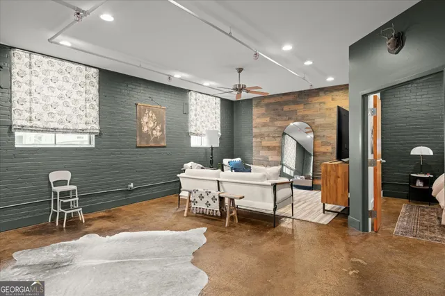 a living room with furniture a window and gym equipment