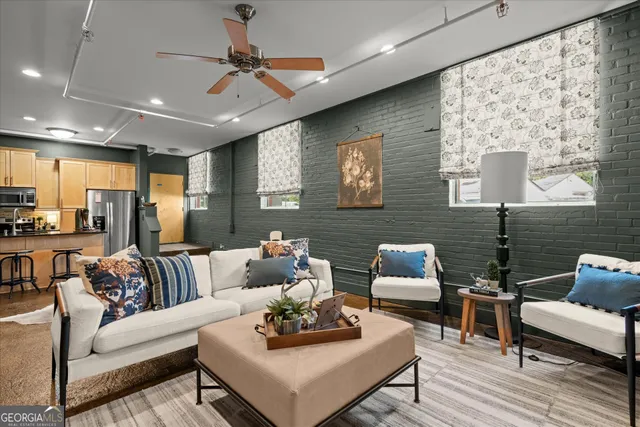 a living room with furniture and a wooden floor