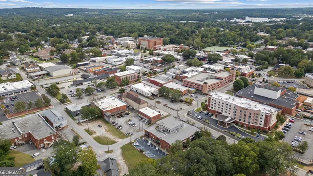 an aerial view of residential houses with city view