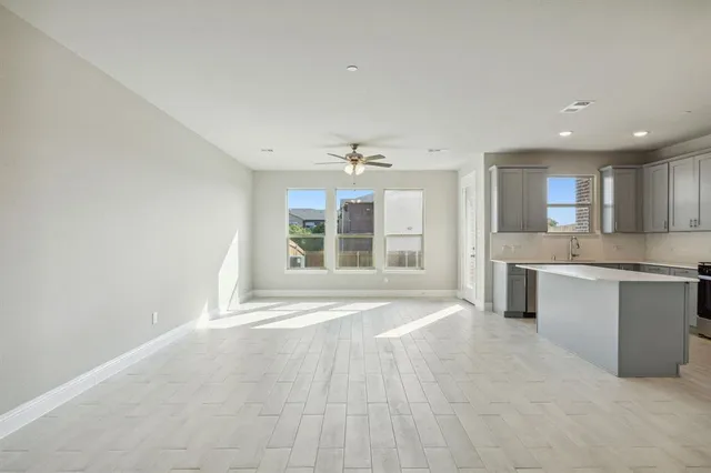 a view of a kitchen with a sink and dishwasher a kitchen stove with wooden cabinets