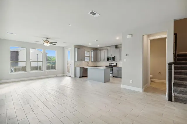 a view of a kitchen with a sink and a large window