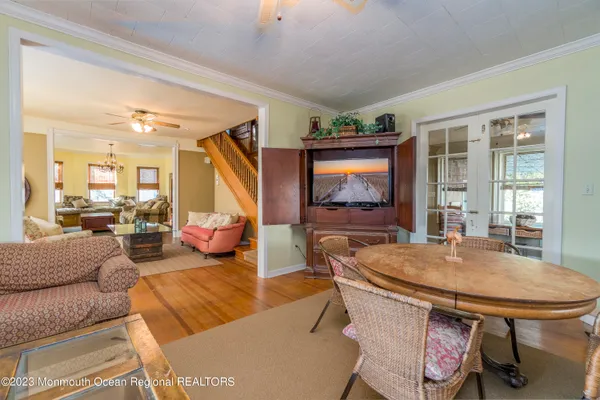 a view of a hallway with wooden floor and windows