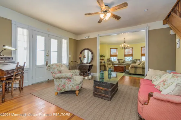 a bedroom with a large bed and a chandelier