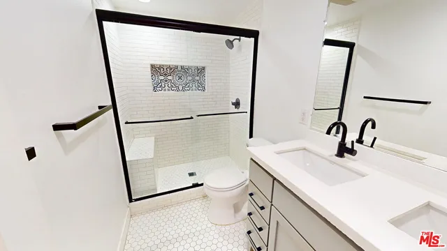 a bathroom with a sink a toilet and a mirror