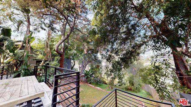 a view of balcony with wooden floor and outdoor seating