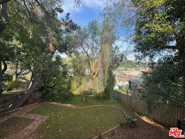 a view of balcony with wooden floor and fence