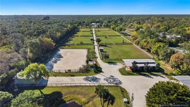 an aerial view of residential houses with outdoor space and swimming pool