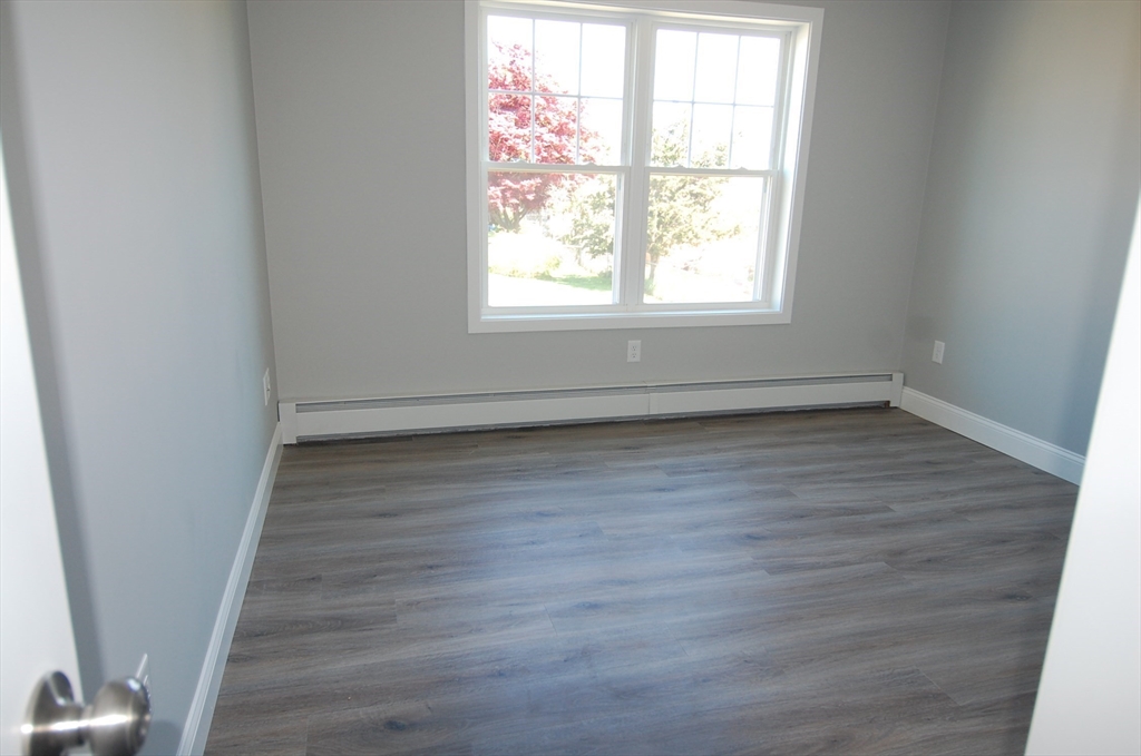 9 Bolton Road, Unit S Dartmouth, MA 02748 - Photo 10 of 19 an empty room with wooden floor and windows