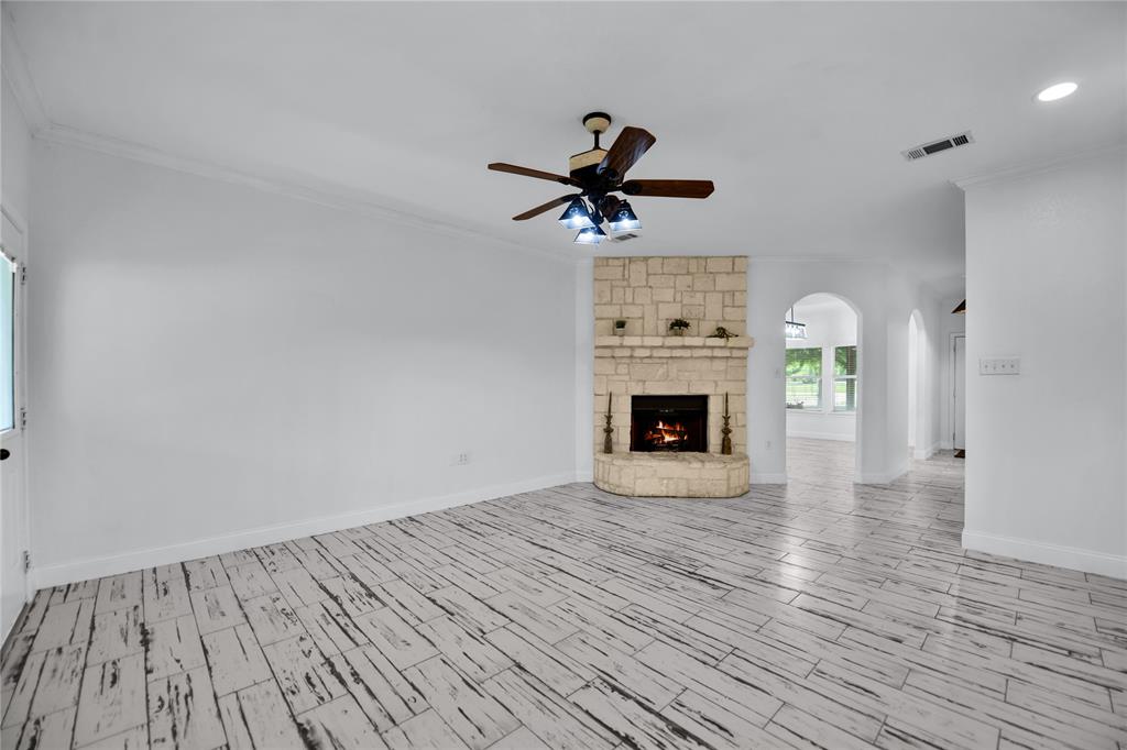 400 Deer Valley Road Weatherford, TX 76085 - Photo 11 of 40 a view of empty room with wooden floor and fireplace