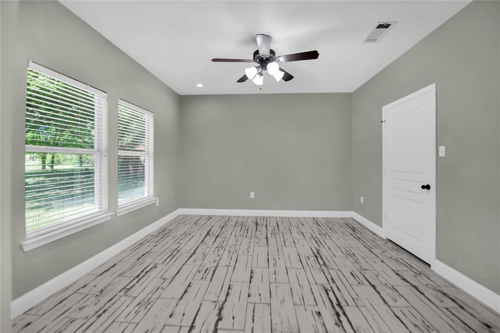400 Deer Valley Road Weatherford, TX 76085 - Photo 13 of 40 a view of an empty room with wooden floor and a window