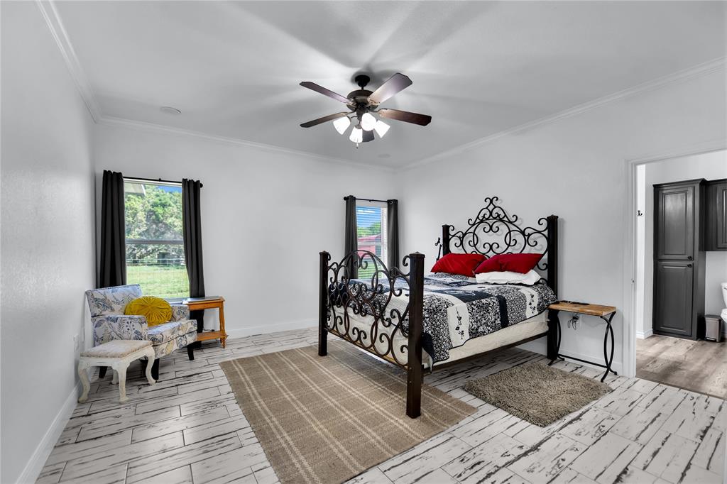 400 Deer Valley Road Weatherford, TX 76085 - Photo 14 of 40 a bedroom with furniture and a wooden floor
