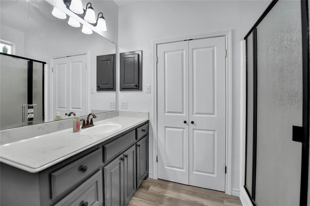 400 Deer Valley Road Weatherford, TX 76085 - Photo 15 of 40 a bathroom with a sink a vanity and a mirror