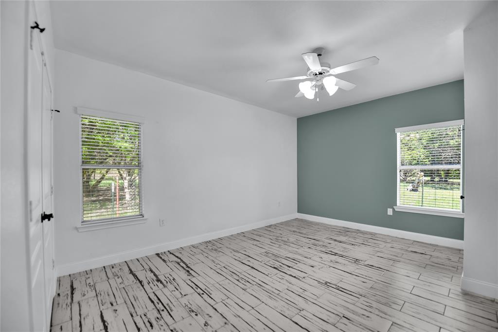 400 Deer Valley Road Weatherford, TX 76085 - Photo 21 of 40 a view of an empty room with wooden floor and a window