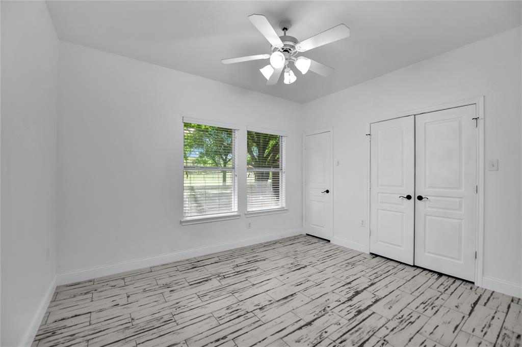 400 Deer Valley Road Weatherford, TX 76085 - Photo 22 of 40 a view of an empty room with wooden floor and a window