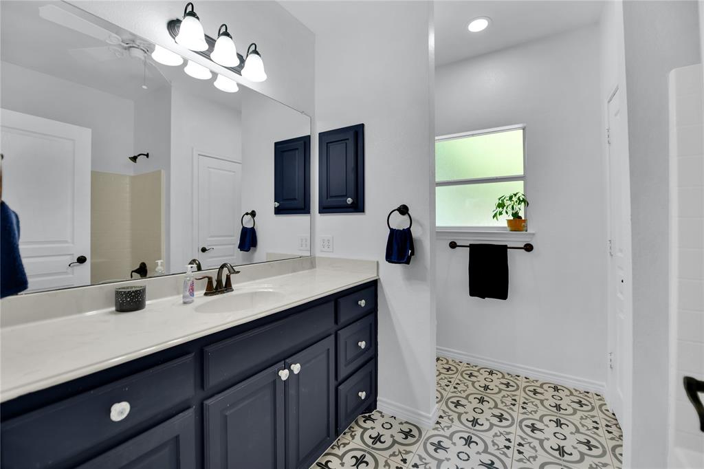 400 Deer Valley Road Weatherford, TX 76085 - Photo 23 of 40 a spacious bathroom with a sink a large mirror and a shower
