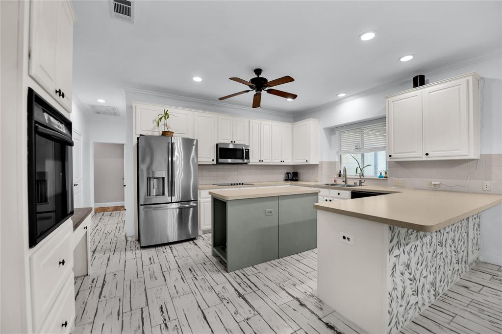 400 Deer Valley Road Weatherford, TX 76085 - Photo 4 of 40 a kitchen with refrigerator cabinets and wooden floor