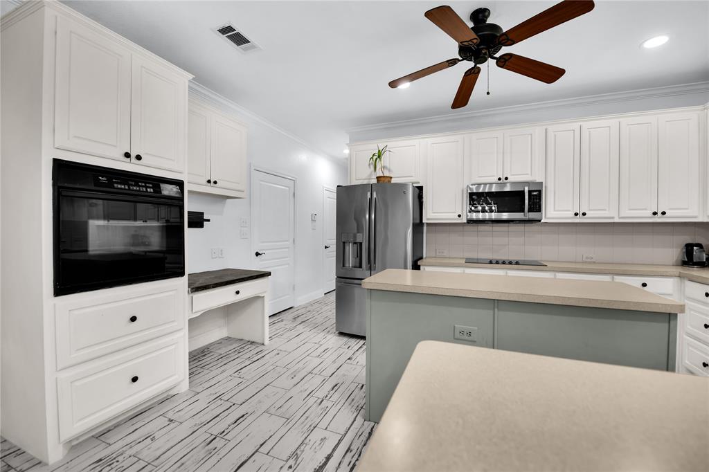 400 Deer Valley Road Weatherford, TX 76085 - Photo 6 of 40 a kitchen with stainless steel appliances a stove microwave and a refrigerator