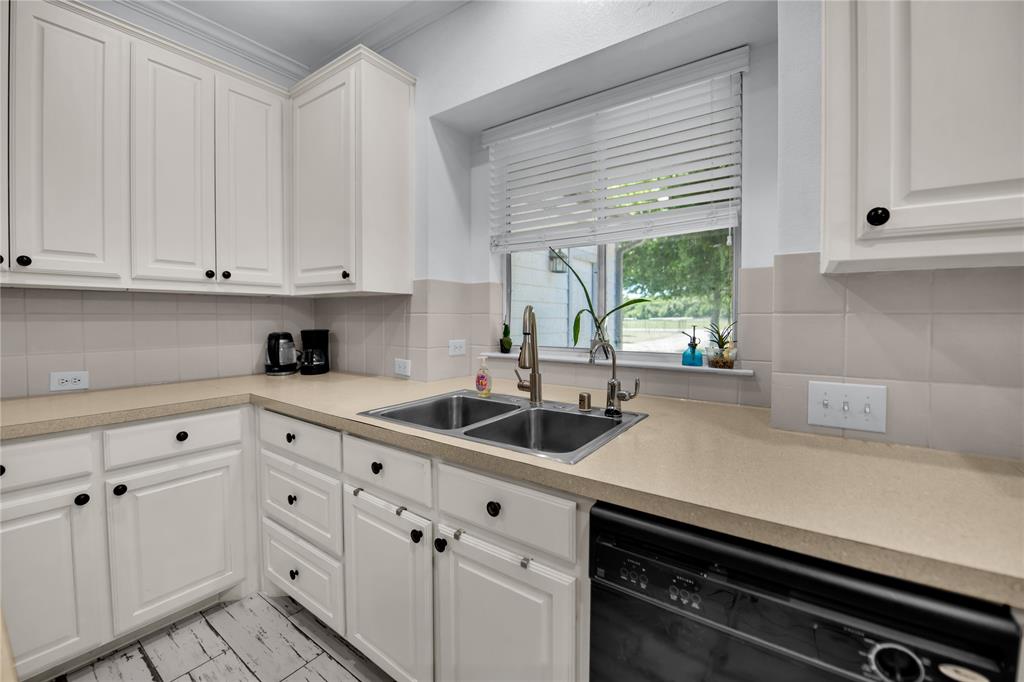 400 Deer Valley Road Weatherford, TX 76085 - Photo 7 of 40 a kitchen with appliances cabinets and a window