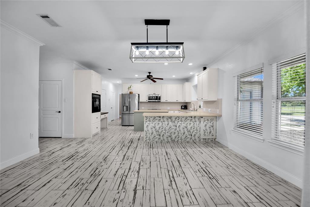 400 Deer Valley Road Weatherford, TX 76085 - Photo 8 of 40 a open kitchen with white cabinets and wooden floor