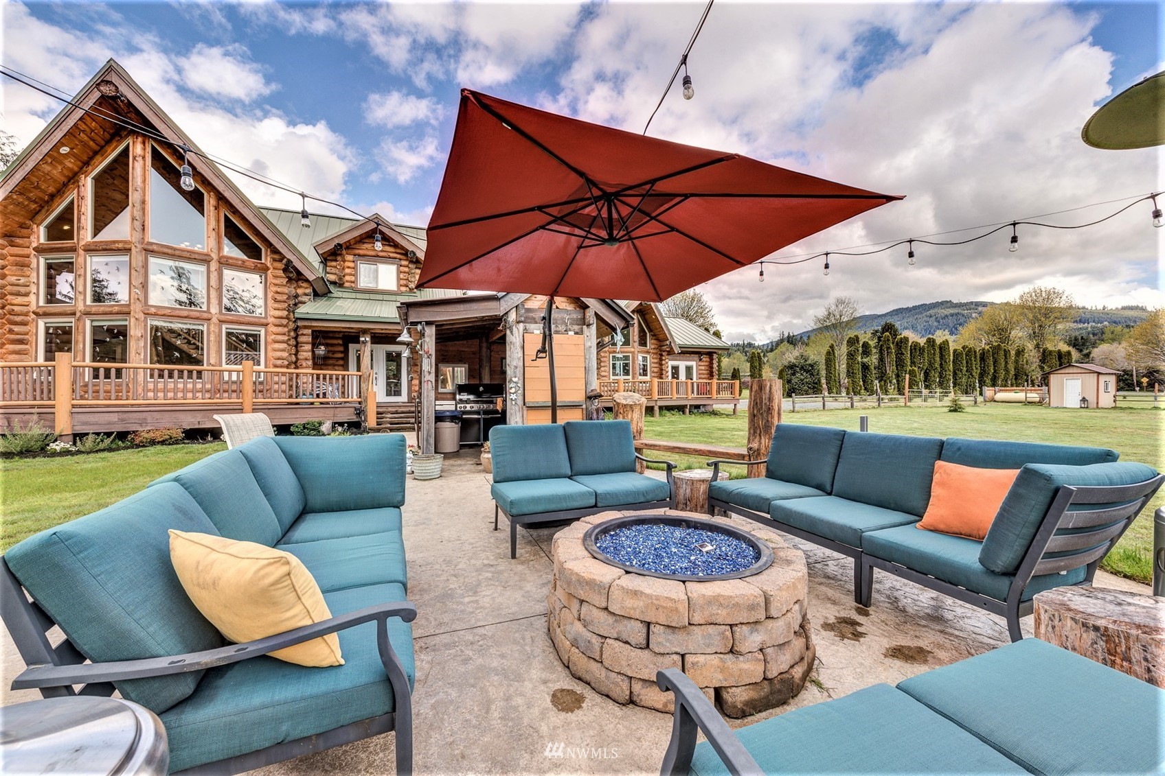 5255 Wickersham Road Acme, WA 98220 - Photo 33 of 40 a view of a patio with couches chairs and a umbrella