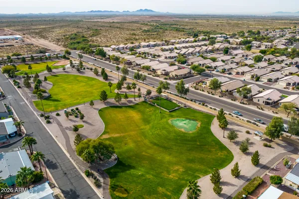 an aerial view of residential house with an outdoor space and seating