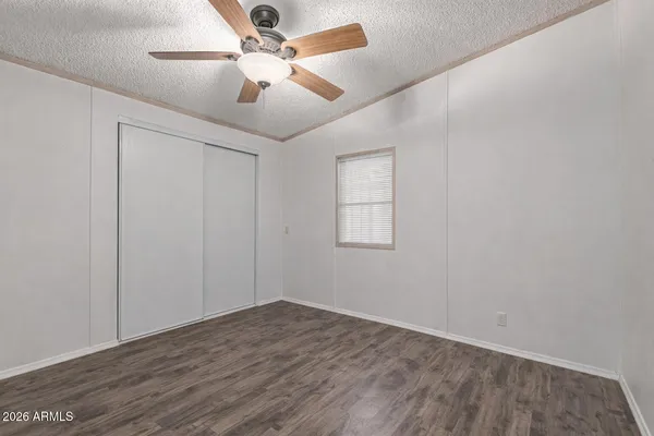 a bathroom with a granite countertop sink toilet and a mirror
