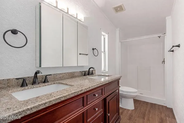 a bathroom with a granite countertop sink and a mirror