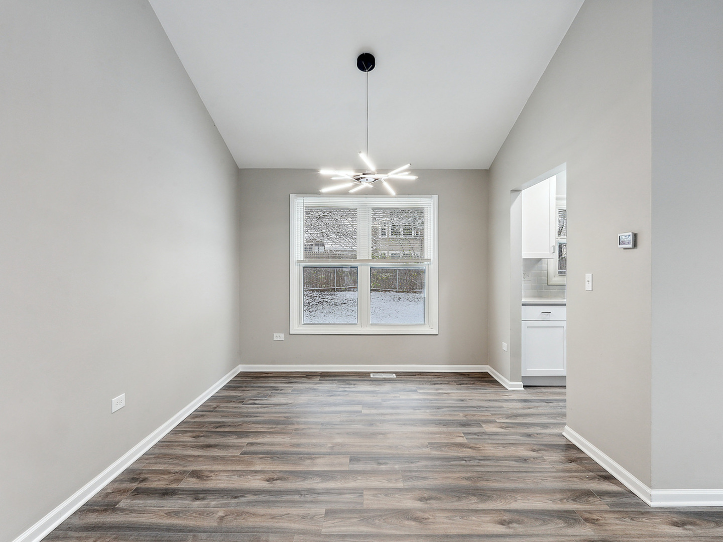 1057 Bothwell Circle Bolingbrook, IL 60440 - Photo 4 of 14 a view of an empty room with wooden floor and a window