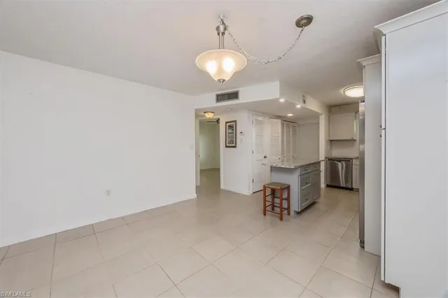 an empty room with fan and entrance