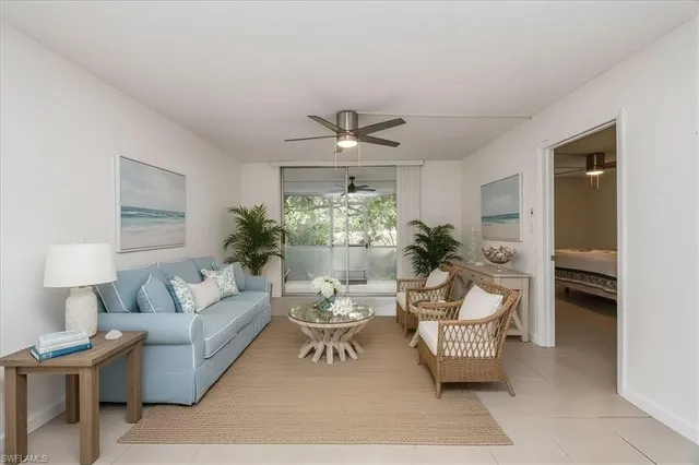 a living room with furniture and a kitchen