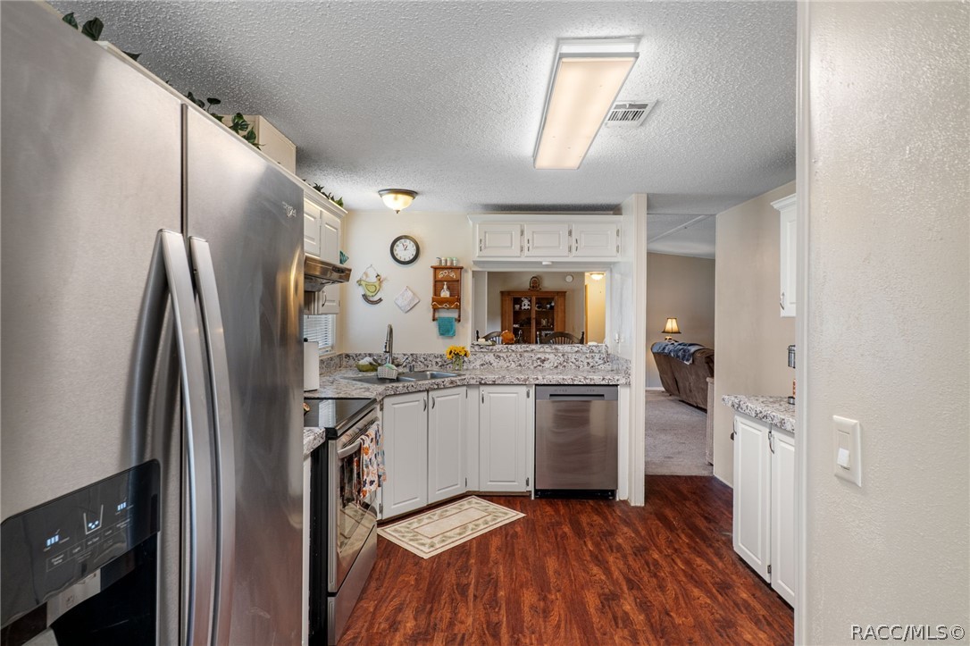 7927 West Cyprian Court Homosassa, FL 34448 - Photo 15 of 40 a kitchen with stainless steel appliances granite countertop a refrigerator and a sink