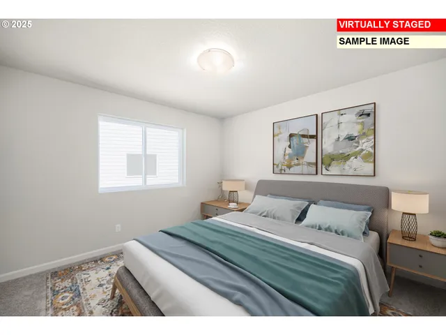 a bedroom with a bed and a painting on the wall