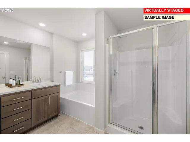 a bathroom with a tub a sink shower and a mirror