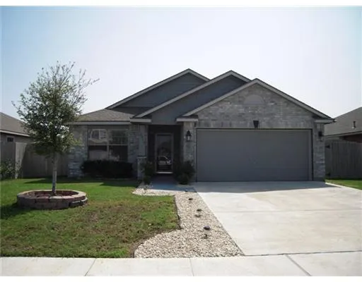 a front view of house with a garden