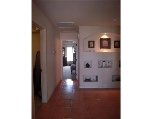 a view of a hallway with two windows