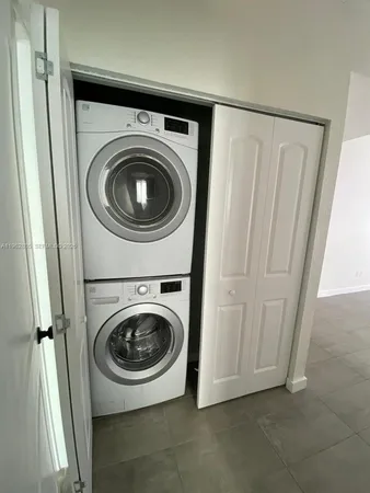 an empty room with a empty space and windows