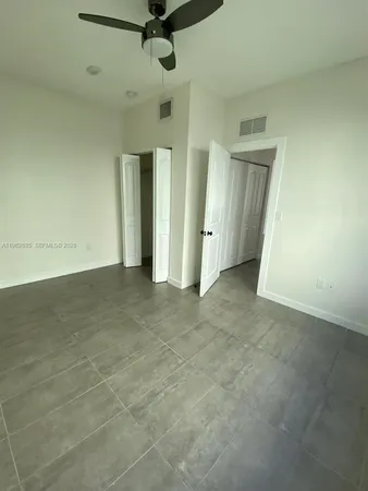 a front view of a building with a yard and garage