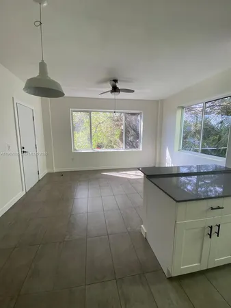 a kitchen with stainless steel appliances granite countertop a stove a sink and a window