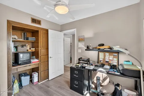 a dining room with wooden floor a chandelier a wooden table and chairs