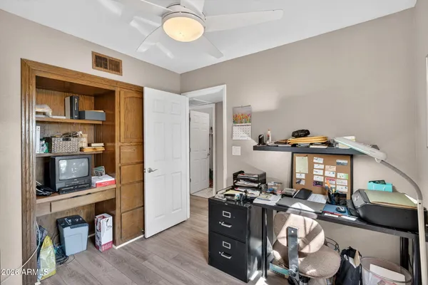 a dining room with wooden floor a chandelier a wooden table and chairs