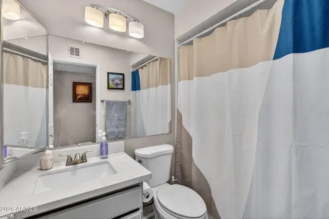 a bedroom with a bed and a large window