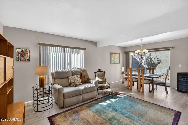 a living room with furniture a fireplace and a floor to ceiling window